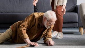 An elderly person who has fallen on the ground.